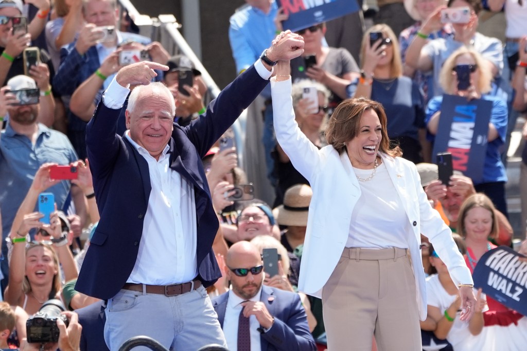 Democratic presidential nominee Vice President Kamala Harris is welcomed by Democratic vice presidential nominee Minnesota Gov. Tim Walz, before she delivers remarks at a campaign event, Wednesday, Aug. 7, 2024, in Eau Claire, Wisc. (AP Photo/Charles Rex Arbogast)