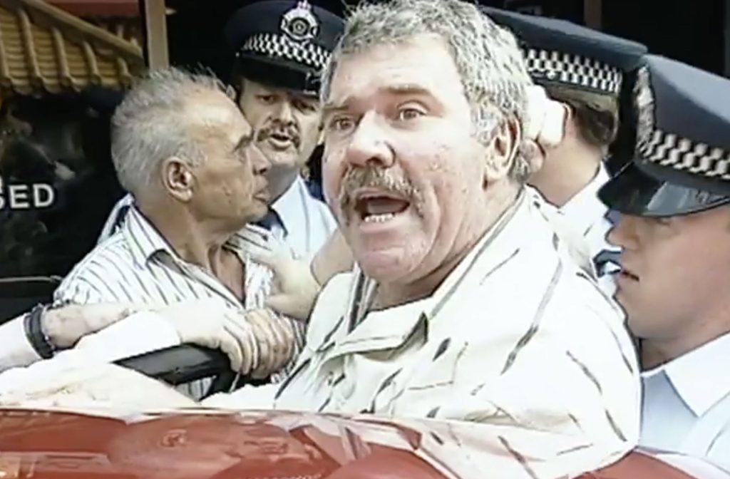 An still image taken from video on Thursday, August 8, 2024 shows Jack Karlson as he appears in the viral 'democracy manifest' video from 1991. Karlson, who has died at the age of 82, became etched into Australian internet folklore when a video of his arrest outside a Chinese restaurant in Brisbane's Fortitude Valley was posted to YouTube 15 years ago. (AAP Image/Supplied by Seven News)