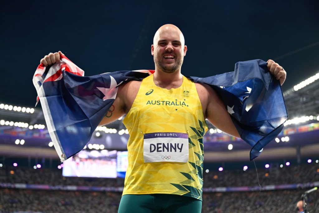 Bronze medallist Australian discus thrower Matthew Denny poses with the Australian after winning a bronze medal in the Men's Discus Throw Final at Stade de France in Saint-Denis, as part of the 2024 Paris Olympic Games, France, Wednesday, August 07, 2024. (AAP Image/Dean Lewins) NO ARCHIVING
