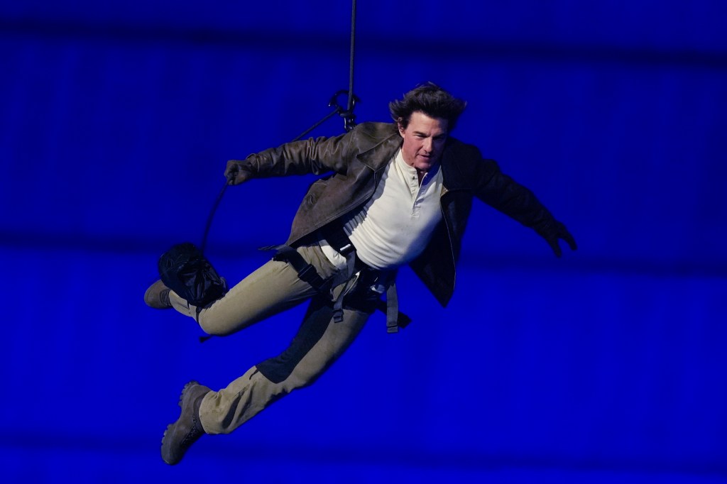 Tom Cruise is lowered on the Stade de France during the 2024 Summer Olympics closing ceremony, Sunday, Aug. 11, 2024, in Saint-Denis, France. (AP Photo/Natacha Pisarenko)