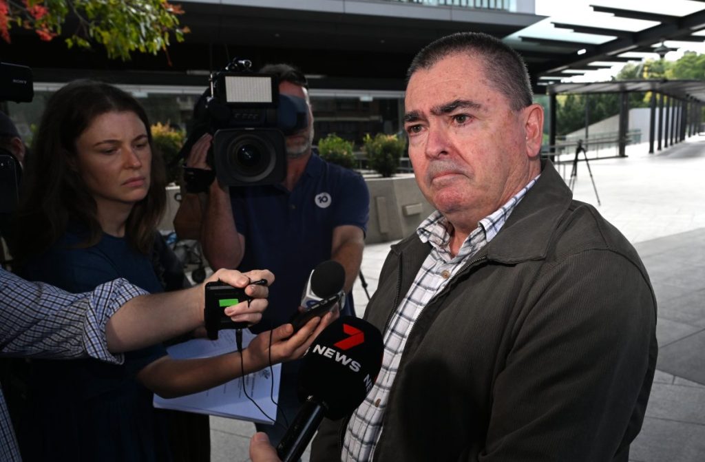 Paul Harris (right), father of Charmaine McLeod is seen leaving the Brisbane Coroners Court, in Brisbane, Wednesday, August 21, 2024. Charmaine McLeod and her four young children died in 2019 in a head-on car crash police say was likely a murder-suicide. (AAP Image/Darren England) NO ARCHIVING