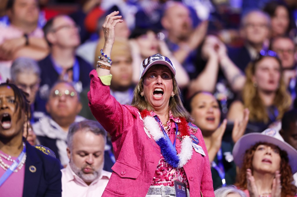 Attendees sing during the Democratic National Convention (DNC) at the United Center in Chicago. EPA/CAROLINE BREHMAN
