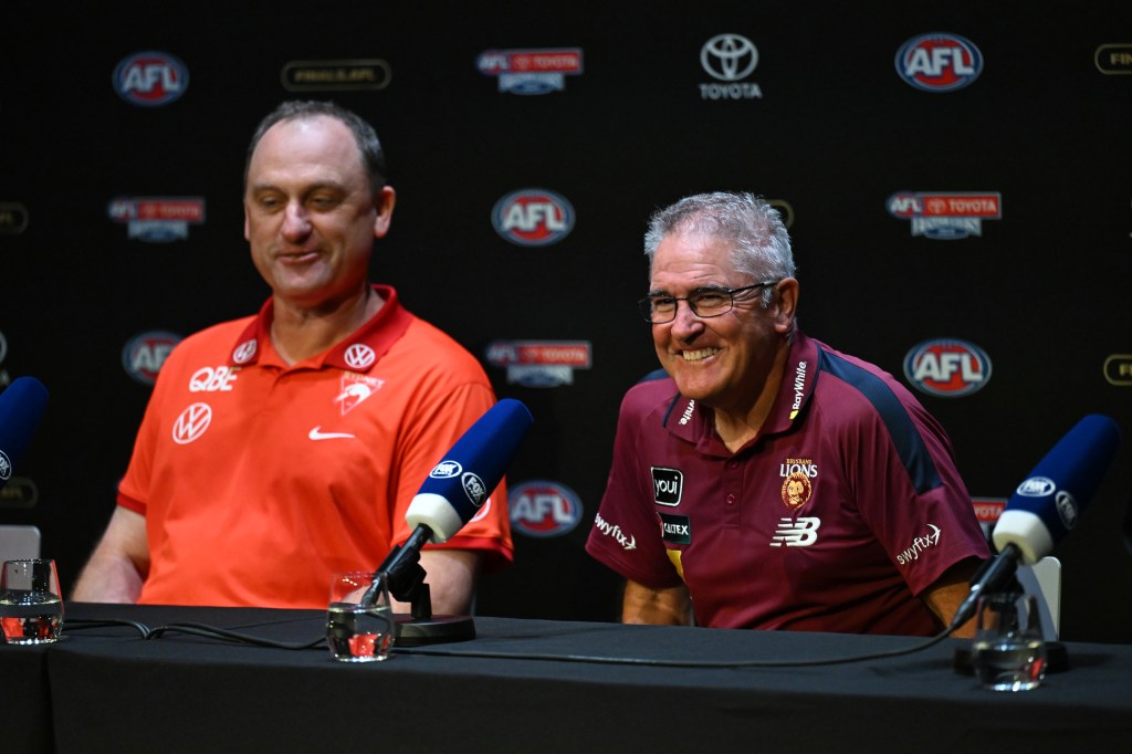 Swans head coach John Longmire (left) and Brisbane Lions head coach Chris Fagan during a press conference ahead of the AFL Grand Final Parade, in Melbourne, Friday, September 27, 2024. The Sydney Swans are set to take on the Brisbane Lions at the MCG for the 2024 AFL Grand Final. (AAP Image/James Ross) NO ARCHIVING