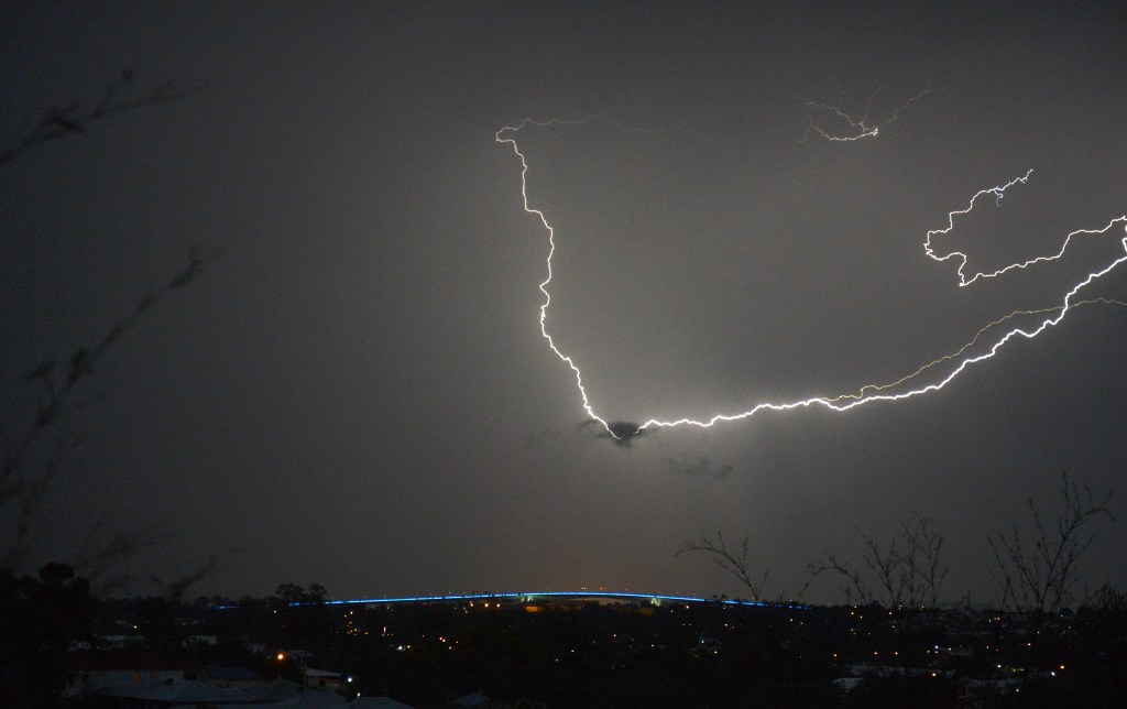 Lightning breaks over the Gateway bridge in Brisbane, Sunday, Nov. 18, 2012. Dangerous thunderstorms with large hailstones have moved through Queensland's southeast corner, with the weather bureau issuing warnings for the region. (AAP Image/Dan Peled) NO ARCHIVING