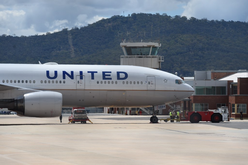 The stranded United Airlines plane UA 863 is seen parked at Canberra airport in Canberra, Friday, Dec. 12, 2014. The plane, diverted from Sydney Airport arrived in Canberra at 9:00 am but passengers were unable to leave because there were no customs and immigration facilities at the domestic airport. (AAP Image/Lukas Coch) NO ARCHIVING