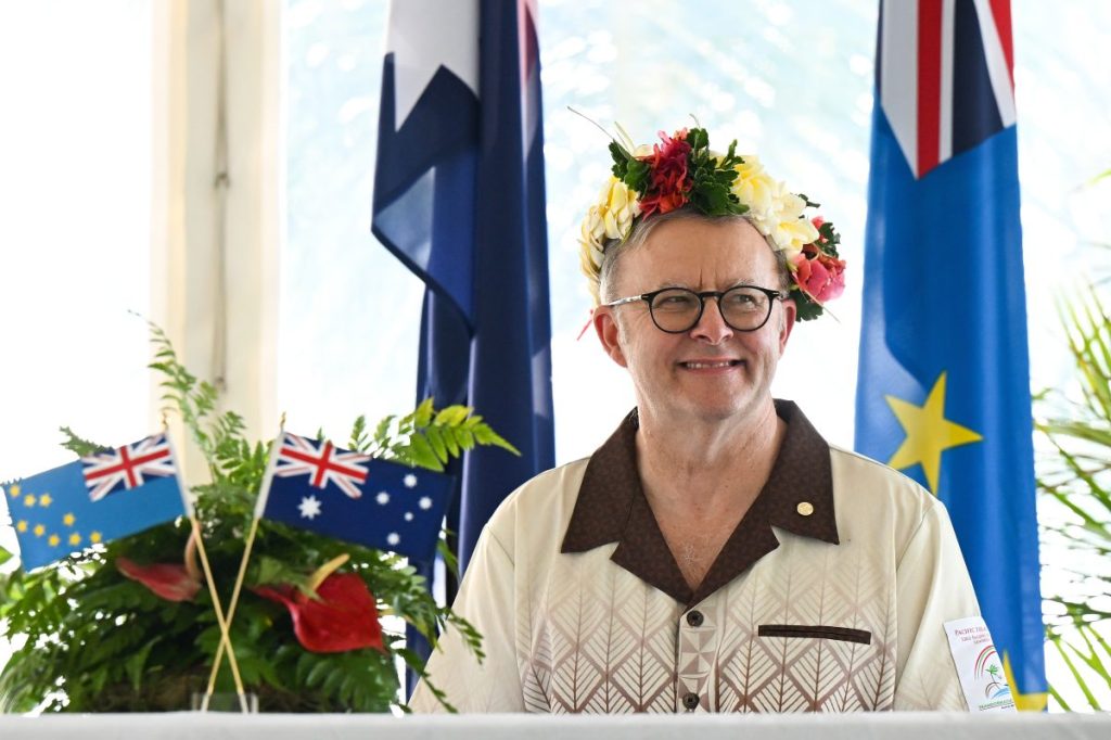 Australian Prime Minister Anthony Albanese wears a floral head piece while signing agreements with Prime Minister of Tuvalu Feleti Teo for the Australia-Tuvalu Falepili Union to come into force at the 53rd Pacific Islands Forum Leaders Meeting in Nuku'alofa, Tonga, Wednesday, August 28, 2024. Leaders from Pacific Island nations are gathering in Tonga for the 53rd Pacific Islands Forum Leaders Meeting. (AAP Image/Lukas Coch) NO ARCHIVING